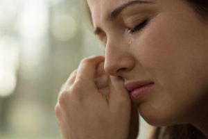 close-up of young woman with problems crying